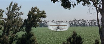 Movie still from “It Happened at the World's Fair” (1963), directed by Norman Taurog – A crop duster plane flying low over a field; Extreme Wide shot, High angle