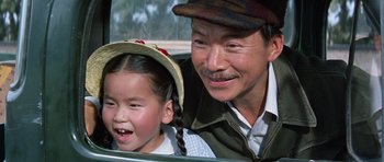 Movie still from “It Happened at the World's Fair” (1963), directed by Norman Taurog – An older man and a young girl in the back of a car; Close Up shot, Over the shoulder angle
