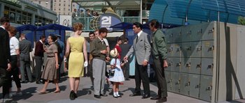 Movie still from “It Happened at the World's Fair” (1963), directed by Norman Taurog – A group of people standing next to each other on the street; Wide shot, High angle