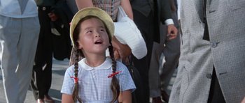 Movie still from “It Happened at the World's Fair” (1963), directed by Norman Taurog – A little girl in a blue dress and a yellow hat; Close Up shot, Low angle
