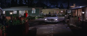 Movie still from “It Happened at the World's Fair” (1963), directed by Norman Taurog – A car parked in a parking lot at night; Wide shot, Low angle