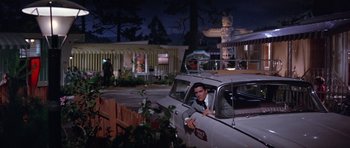 Movie still from “It Happened at the World's Fair” (1963), directed by Norman Taurog – A man sitting in the driver's seat of a car; Wide shot, Low angle