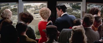 Movie still from “It Happened at the World's Fair” (1963), directed by Norman Taurog – A man and a woman looking out of a window; Wide shot, Over the shoulder angle