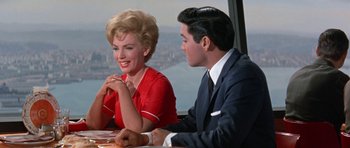 Movie still from “It Happened at the World's Fair” (1963), directed by Norman Taurog – A man and a woman sitting at a table; Medium shot, Over the shoulder angle