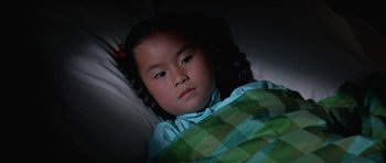 Movie still from “It Happened at the World's Fair” (1963), directed by Norman Taurog – A little girl laying in a bed with a blanket; Close Up shot, High angle