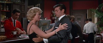 Movie still from “It Happened at the World's Fair” (1963), directed by Norman Taurog – A man and a woman are dancing in a room; Medium shot, Over the shoulder angle