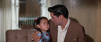 Movie still from “It Happened at the World's Fair” (1963), directed by Norman Taurog – A man and a little girl looking at each other; Close Up shot, Over the shoulder angle