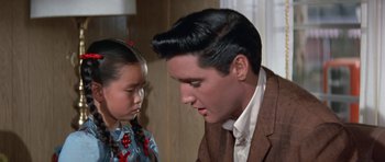 Movie still from “It Happened at the World's Fair” (1963), directed by Norman Taurog – A man and a little girl looking at each other; Close Up shot, Over the shoulder angle