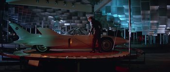 Movie still from “It Happened at the World's Fair” (1963), directed by Norman Taurog – A man standing in front of an airplane on display; Wide shot, High angle