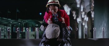 Movie still from “It Happened at the World's Fair” (1963), directed by Norman Taurog – A young girl being held up by an older man; Medium shot, Over the shoulder angle