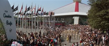 Movie still from “It Happened at the World's Fair” (1963), directed by Norman Taurog – A crowd of people standing in front of a building; Extreme Wide shot, High angle