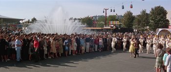 Movie still from “It Happened at the World's Fair” (1963), directed by Norman Taurog – A crowd of people standing in front of a water fountain; Wide shot, High angle