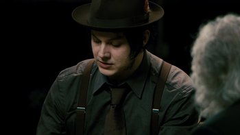 Movie still from “It Might Get Loud” (2008), directed by Davis Guggenheim – A man wearing a hat and suspenders and wearing a tie; Close Up shot, High angle