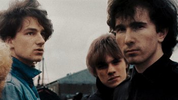 Movie still from “It Might Get Loud” (2008), directed by Davis Guggenheim – A group of young men standing next to each other; Close Up shot, Low angle