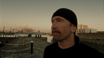 Movie still from “It Might Get Loud” (2008), directed by Davis Guggenheim – A man in a black shirt and a black hat; Close Up shot, Low angle