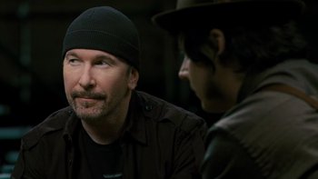 Movie still from “It Might Get Loud” (2008), directed by Davis Guggenheim – A man wearing a black hat and a black jacket; Close Up shot, Over the shoulder angle