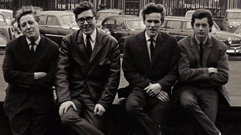 Movie still from “It Might Get Loud” (2008), directed by Davis Guggenheim – Two young men sitting next to each other on a bench; Medium shot, Overhead angle