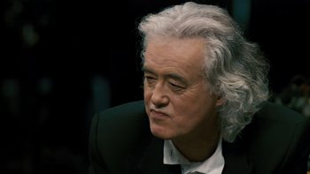Movie still from “It Might Get Loud” (2008), directed by Davis Guggenheim – An older man in a suit and white shirt; Close Up shot, High angle