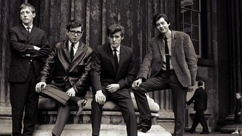 Movie still from “It Might Get Loud” (2008), directed by Davis Guggenheim – A group of young men sitting on top of a bench; Medium shot, Low angle