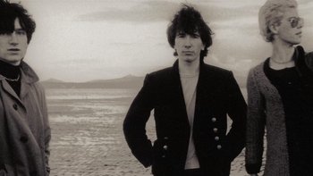 Movie still from “It Might Get Loud” (2008), directed by Davis Guggenheim – A man standing on the beach in front of the ocean; Close Up shot, Low angle