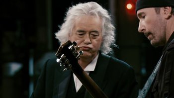 Movie still from “It Might Get Loud” (2008), directed by Davis Guggenheim – A man with a white beard holding a guitar; Close Up shot, Over the shoulder angle