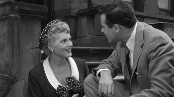 Movie still from “It Should Happen to You” (1954), directed by George Cukor – An old photo of a man and a woman; Medium shot, High angle