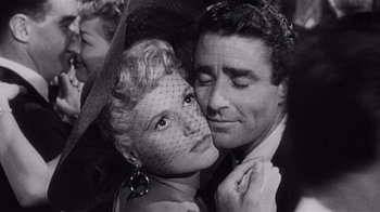 Movie still from “It Should Happen to You” (1954), directed by George Cukor – An old black and white photo of a man and a woman; Close Up shot, Overhead angle