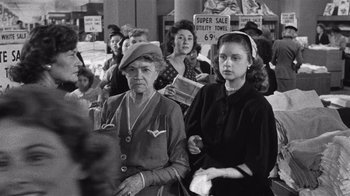 Movie still from “It Should Happen to You” (1954), directed by George Cukor – A group of women standing next to each other in a room; Medium shot, Low angle