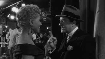 Movie still from “It Should Happen to You” (1954), directed by George Cukor – A man and a woman are talking to each other; Medium shot, Over the shoulder angle