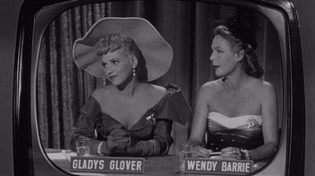 Movie still from “It Should Happen to You” (1954), directed by George Cukor – A black and white photo of two women sitting at a table; Medium shot, High angle