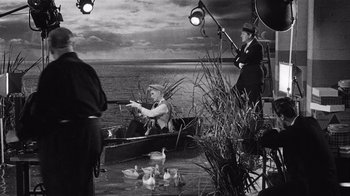 Movie still from “It Should Happen to You” (1954), directed by George Cukor – Two men in a row boat on the water; Wide shot, High angle