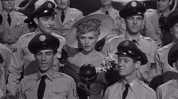 Movie still from “It Should Happen to You” (1954), directed by George Cukor – A group of men in uniform posing for a picture; Medium shot, High angle