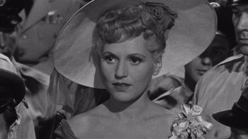 Movie still from “It Should Happen to You” (1954), directed by George Cukor – An old black and white photo of a woman wearing a hat; Close Up shot, High angle