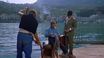 Movie still from “It Started in Naples” (1960), directed by Melville Shavelson – A group of men standing around a body of water; Wide shot, High angle