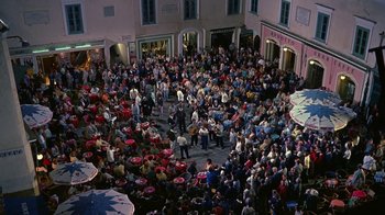 Movie still from “It Started in Naples” (1960), directed by Melville Shavelson – An aerial view of a crowd of people sitting in a circle; Extreme Wide shot, High angle