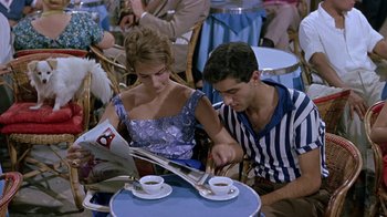 Movie still from “It Started in Naples” (1960), directed by Melville Shavelson – A man and a woman sitting at a table; Medium shot, High angle