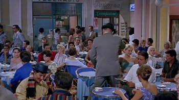Movie still from “It Started in Naples” (1960), directed by Melville Shavelson – A group of people sitting at tables in a restaurant; Wide shot, High angle