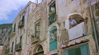 Movie still from “It Started in Naples” (1960), directed by Melville Shavelson – A group of people standing on a balcony; Wide shot, Low angle