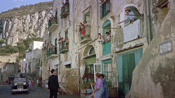 Movie still from “It Started in Naples” (1960), directed by Melville Shavelson – A group of people standing on the side of a building; Wide shot, High angle
