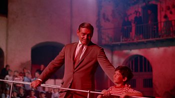 Movie still from “It Started in Naples” (1960), directed by Melville Shavelson – A man and a boy are standing next to each other; Medium shot, Low angle