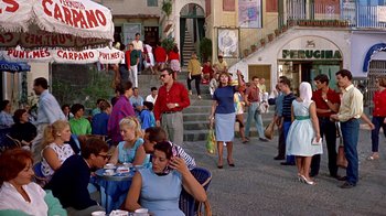 Movie still from “It Started in Naples” (1960), directed by Melville Shavelson – A group of people sitting at tables on a sidewalk; Wide shot, High angle