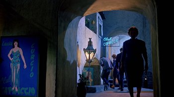 Movie still from “It Started in Naples” (1960), directed by Melville Shavelson – A group of people walking down a street at night; Wide shot, Low angle