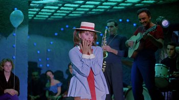 Movie still from “It Started in Naples” (1960), directed by Melville Shavelson – A woman wearing a red hat and a blue jacket; Medium shot, Low angle