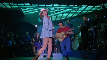 Movie still from “It Started in Naples” (1960), directed by Melville Shavelson – A man and a woman are dancing on a stage; Wide shot, Low angle