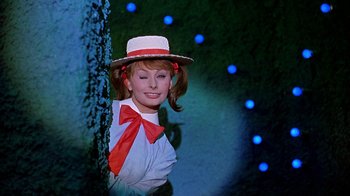 Movie still from “It Started in Naples” (1960), directed by Melville Shavelson – A woman wearing a red bow tie and a white hat; Close Up shot, Low angle