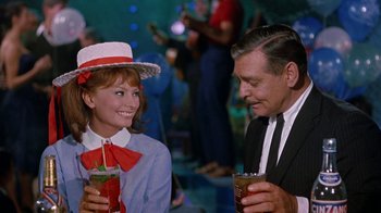Movie still from “It Started in Naples” (1960), directed by Melville Shavelson – A man and a woman are holding drinks and smiling; Medium shot, Over the shoulder angle