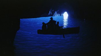 Movie still from “It Started in Naples” (1960), directed by Melville Shavelson – Three people are sitting on a boat in the middle of the ocean; Extreme Wide shot, High angle