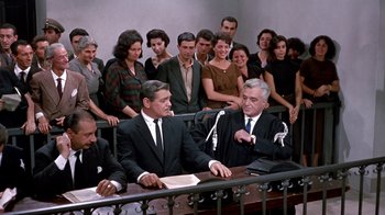 Movie still from “It Started in Naples” (1960), directed by Melville Shavelson – A group of people sitting in front of a judge; Wide shot, High angle