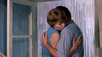 Movie still from “It Started in Naples” (1960), directed by Melville Shavelson – A man and a woman hugging in a room; Medium shot, Low angle