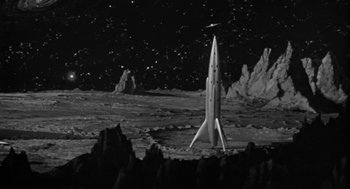 Movie still from “It! The Terror from Beyond Space” (1958), directed by Edward L. Cahn – A black and white photo of a rocket on the surface of the moon; Extreme Wide shot, High angle